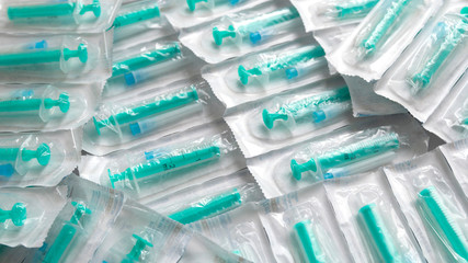 Medical syringes in a package. A bunch of unused, packaged syringes.