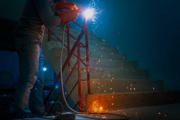 Industrial Worker labourer welding Handrail in the construction site