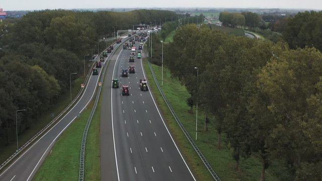 Aerial shot of farmers protesting on a highway in the Netherlands, lowering 4K