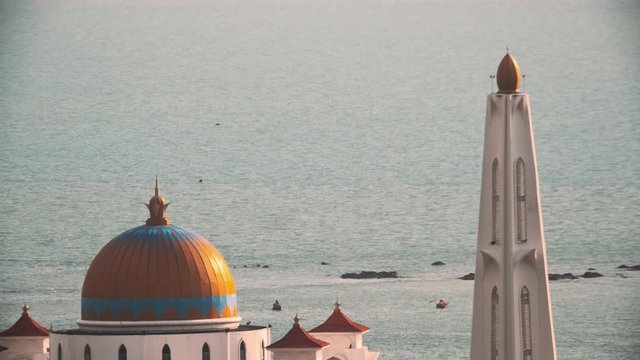 Melaka Straits Mosque facing calm and peaceful ocean at day, no people