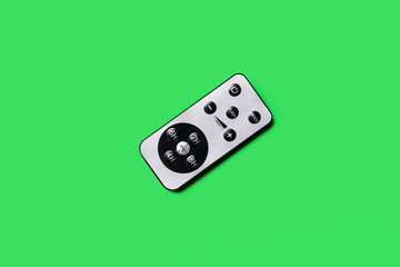 gray remote control on a green background