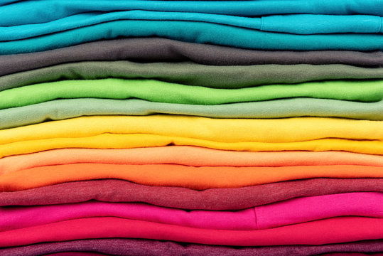 Colorful stack of t-shirts clothes texture background