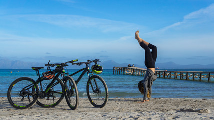 young girl handstand on the beach