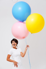 portrait laughing woman with bunch of colorful balloons 