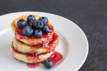 Cottage cheese pancakes, syrniki with fresh berries.