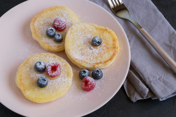 Cottage cheese pancakes, syrniki with fresh berries.