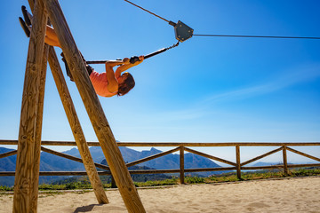 Fototapeta na wymiar Adult woman having fun on zipline