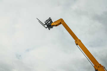 Forklift industrial loader or stacker against sky.