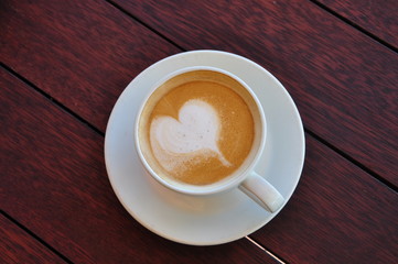 Heart - Coffee on wooden table top view - Love concept