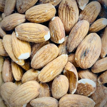 Different nuts and dried fruits in the package in the supermarket. A close-up. Mobile photo.