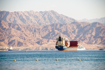 Photo of landscape in Eilat. View with ship, mountains and bay.