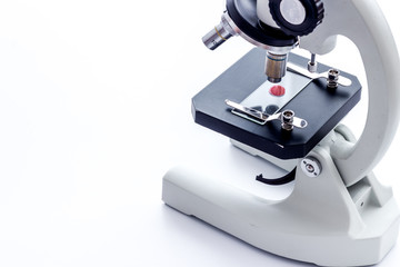 Research with microscope. Laboratory backround with blood sample on white table copy space