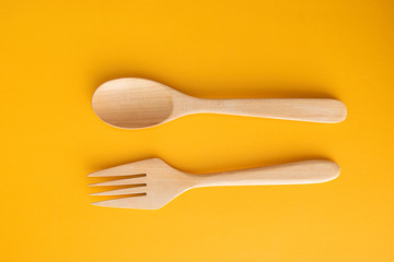 wood spoon on yellow background in food background concept