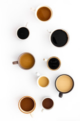 Cups of hot drinks on white desk top view