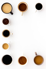 Cups of hot drinks on white background from above frame copy space