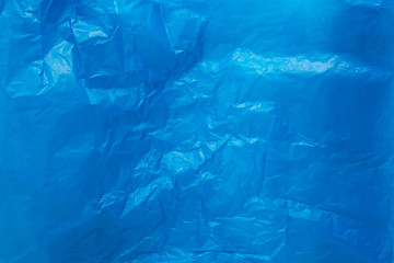 Blue wrinkled plastic bag texture background.