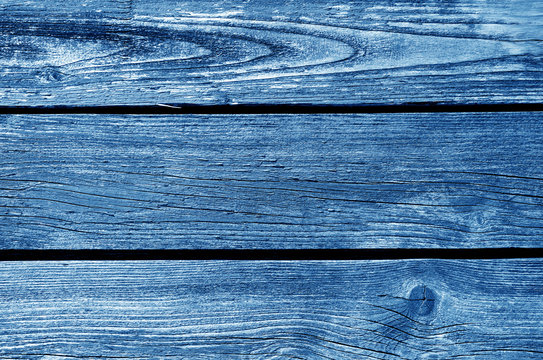 Old grungy wooden planks background in navy blue tone.