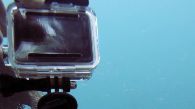 setting up gopro action camera for underwater shot; pov