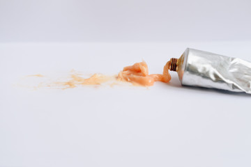 Squeezed out tubes of hair dye on a white background