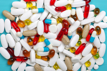 Heap of pills on blue