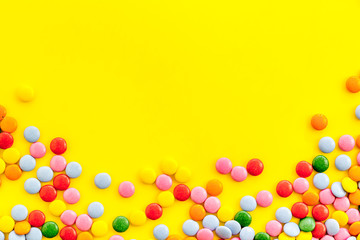 Color candy on yellow tabe top-down frame space for text