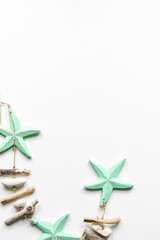 Turqouise starfish with wood and peeble decoration on a white background