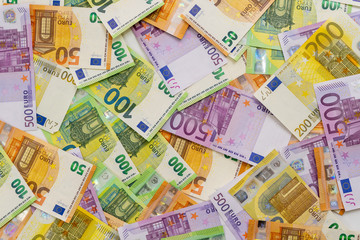 European currency lies on the table. Banknotes five hundred, one hundred, two hundred, fifty euros are scattered in a chaotic manner. Blank for design, background. Close-up. View from above.