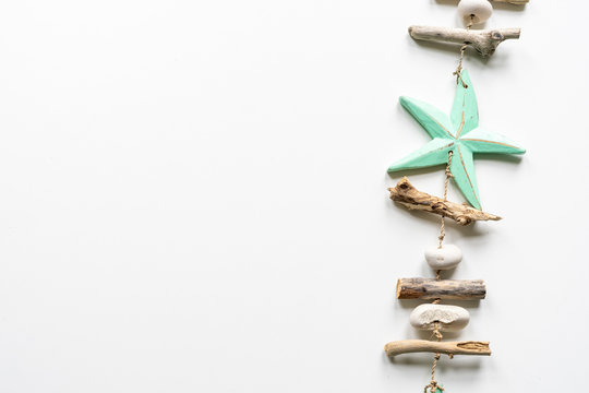 Turqouise starfish with wood and peeble decoration on a white background
