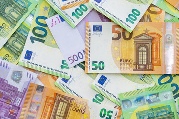European currency lies on the table. Banknotes five hundred, one hundred, two hundred, fifty euros are scattered in a chaotic manner. Blank for design, background. Close-up. View from above.