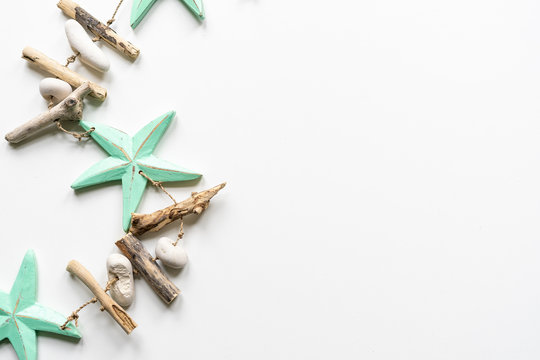 Turqouise starfish with wood and peeble decoration on a white background