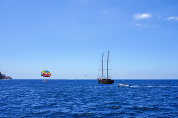 Recreational boat and kite surf off the coast near Puerto Mogán