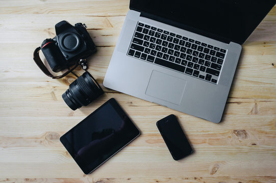 Photo journalism. Laptop, camera, tablet, note, camera lens.