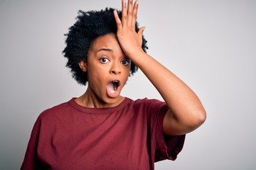Young beautiful African American afro woman with curly hair wearing casual t-shirt standing...