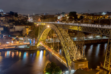 Fototapeta na wymiar night photography of dom luis I bridge double deck metal arch bridge porto