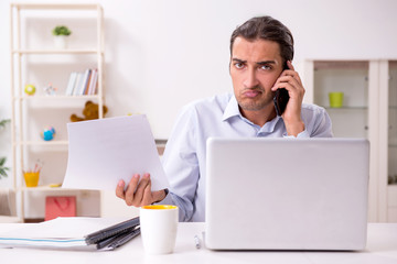 Young male businessman working at home