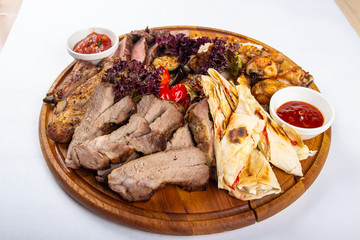 studio photo meat assortment with sauce and pita menu
