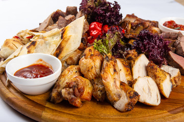 studio photo meat assortment with sauce and pita menu