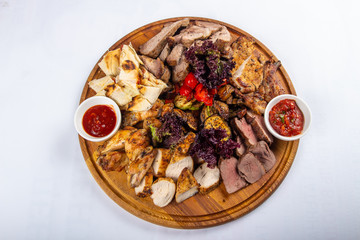 studio photo meat assortment with sauce and pita menu