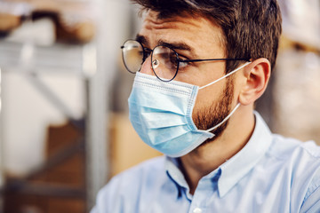 Closeup of handsome businessman wearing protective sterile mask.