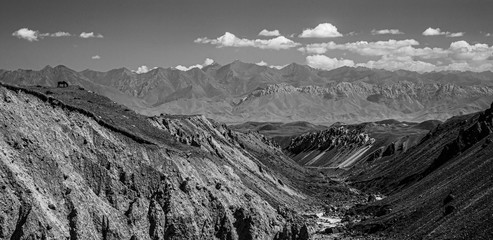 Beautiful landscape. Hilly area. The sandy gorge. View of peaks. Black and white.