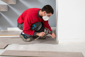 repairman laying flooring