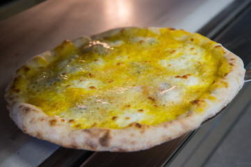 detail of the hands of a pizza chef chef who works for the various stages of preparing a real Italian pizza homemade with yeast flour and water.