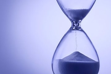 Blue toned hourglass with running sand