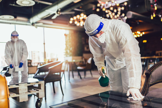 Professional Workers In Hazmat Suits Disinfecting Indoor Of Cafe Or Restaurant, Pandemic Health Risk, Coronavirus