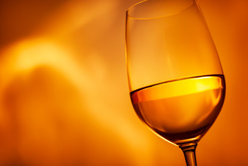 Glass of glowing golden white wine in close up