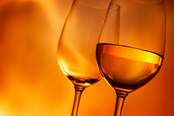 Two wineglasses, one with white wine
