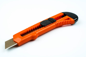 Clerical knife of orange color isolated on a white background.