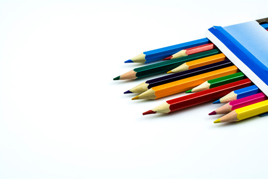 Colored pencils in a box isolated on a white background.