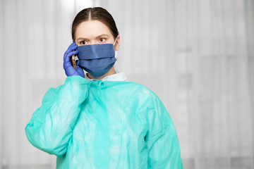 doctor in protective uniform holds phone in hand, woman calls an ambulance on phone, social networks