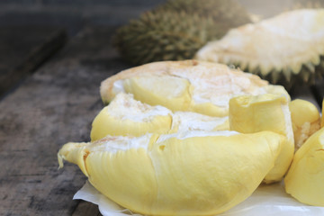 Durian riped and fresh with yellow colour on wooden table.